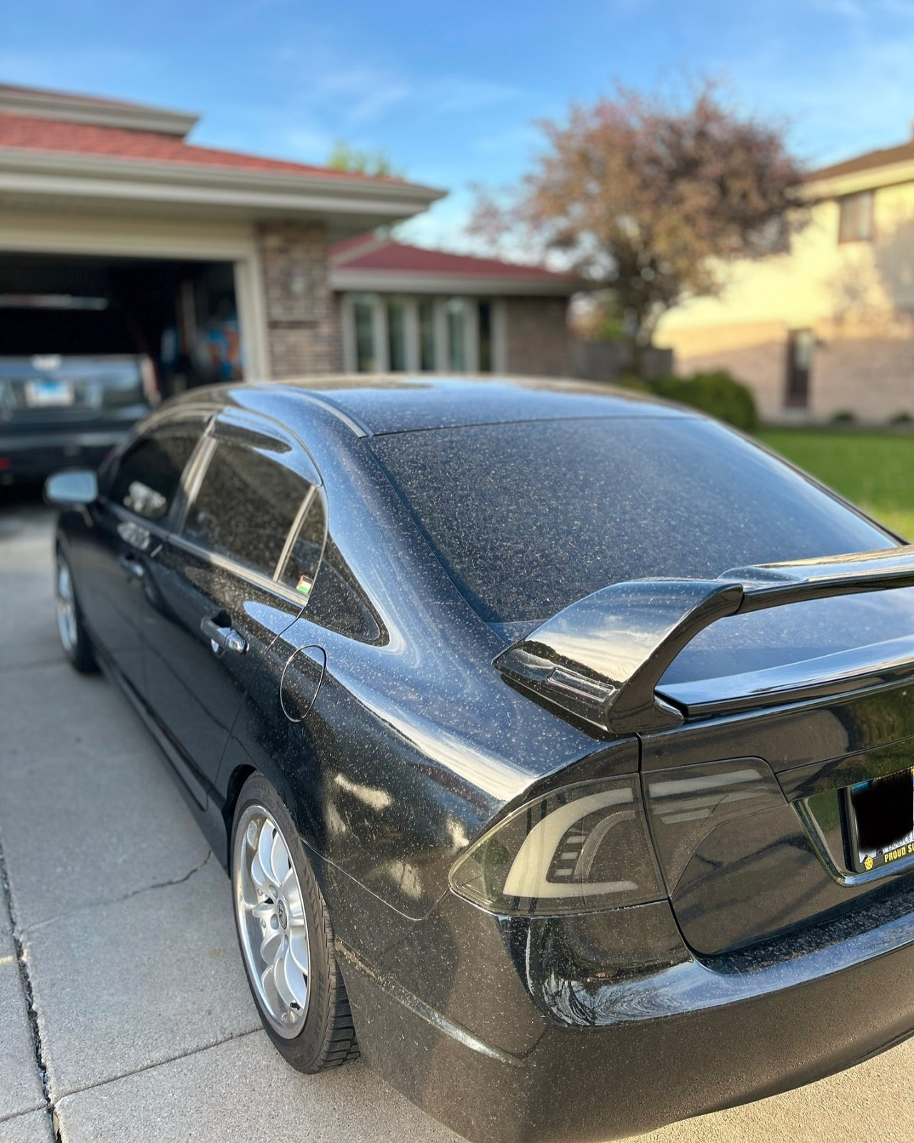 Honda Civic with dark ceramic window tint reflecting the sky